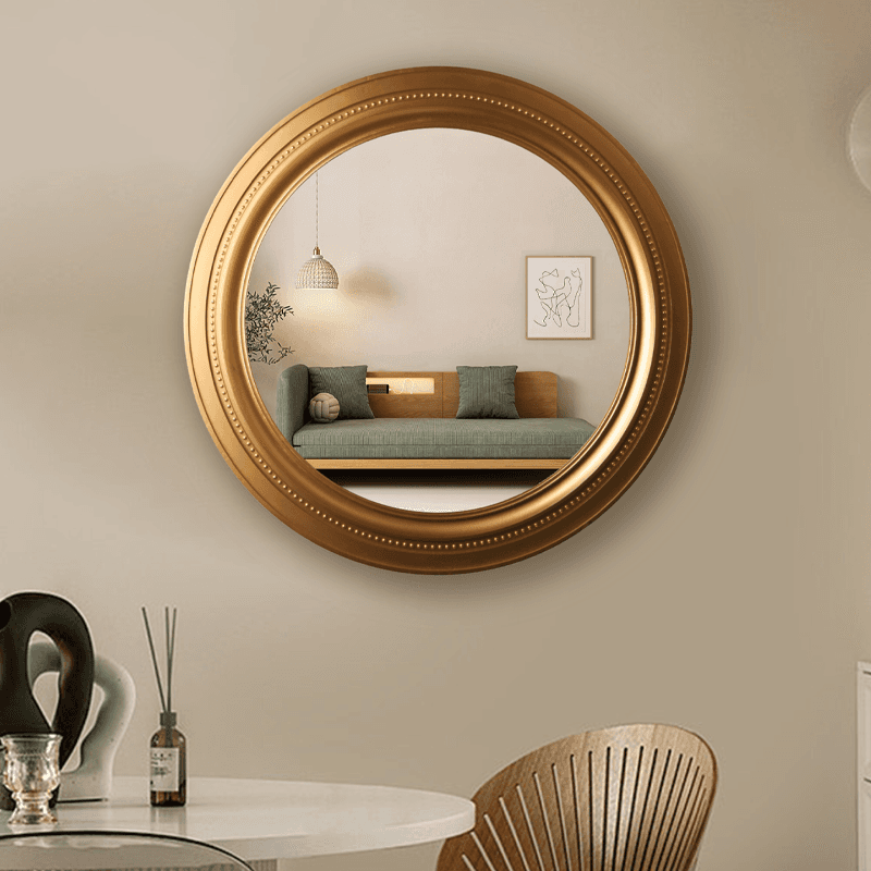 Espejo moderno con marco redondo dorado de 75 cm.